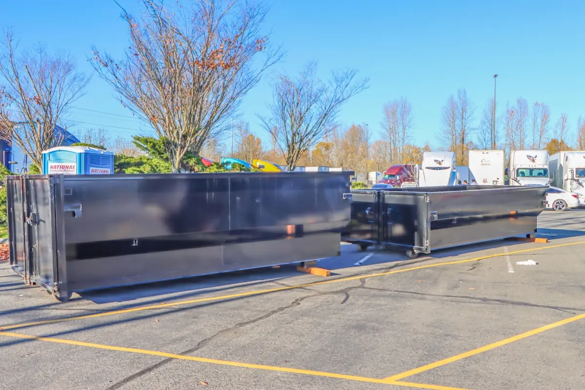 Professional dumpster rental service with roll-off container on residential driveway in Limerick
